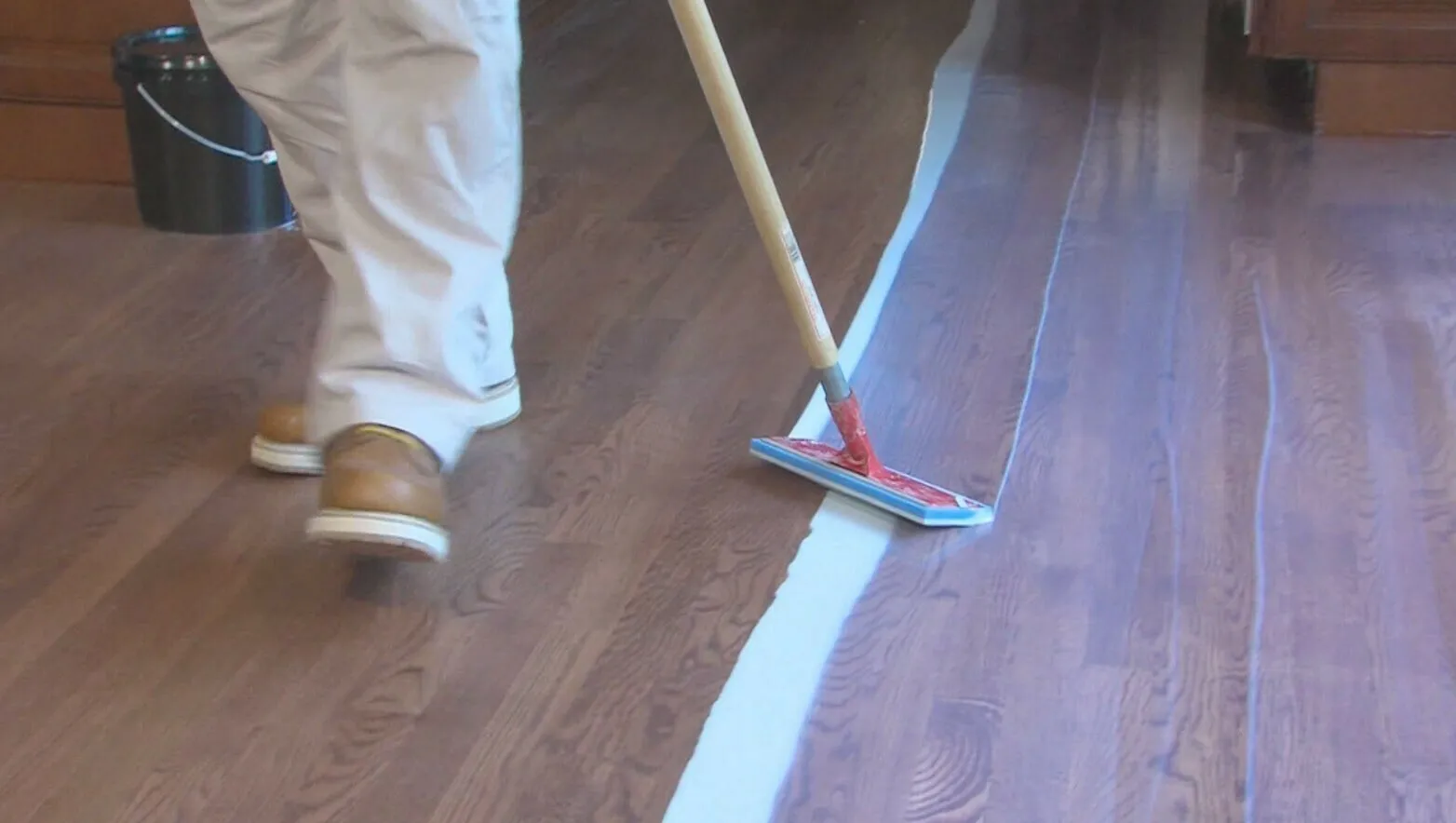 McSwain technician applying a top coat to a hardwood floor