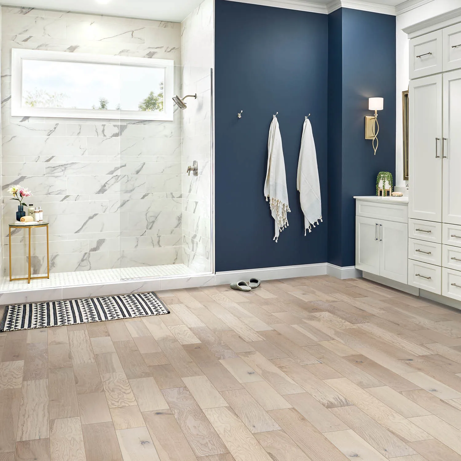Waterproof light wood-look luxury vinyl plank flooring in a bathroom | McSwain Carpets & Floors